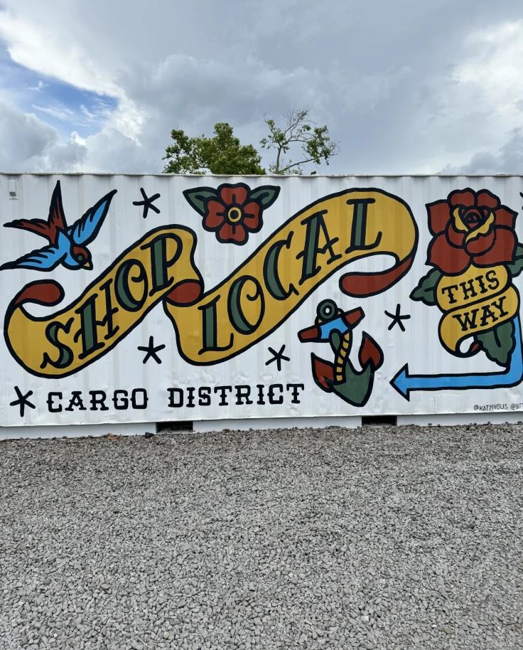 Wall art with the text 'Shop local' painted.