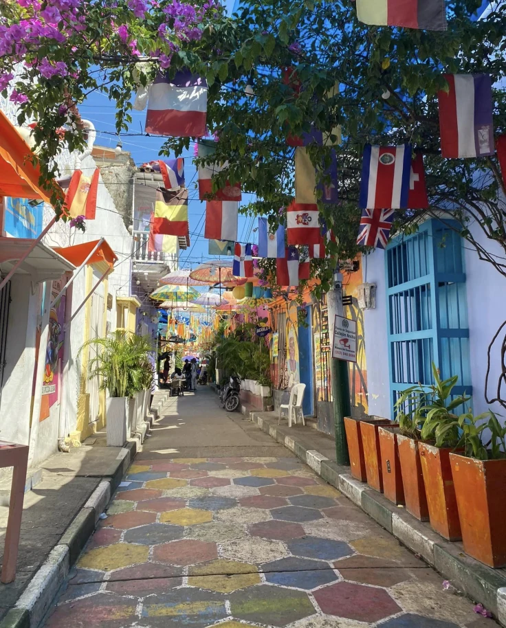 A colorful street with hanging flags.