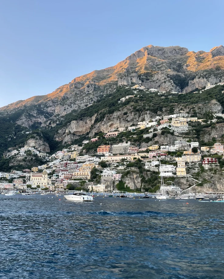A view from the ocean in Positano facing the iconic town that is built on the mountainside.