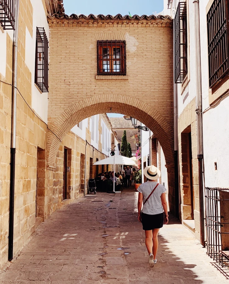 woman walking down alleyway