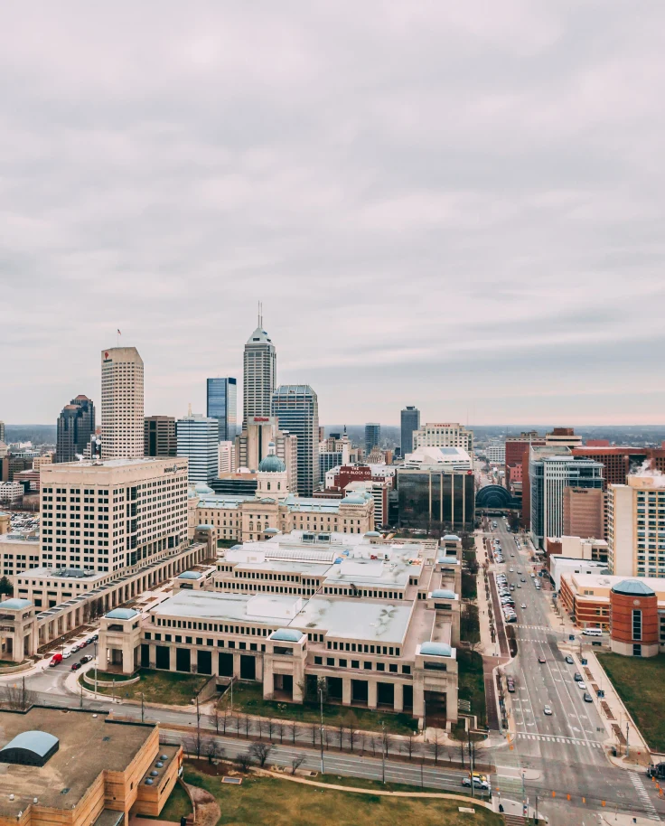 View of buildings and skyscrapers in downtown Indianapolis with a cloudy, grey sky