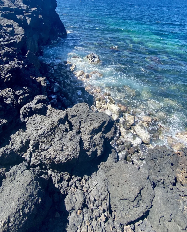 Rocky cliffs next to a body of water
