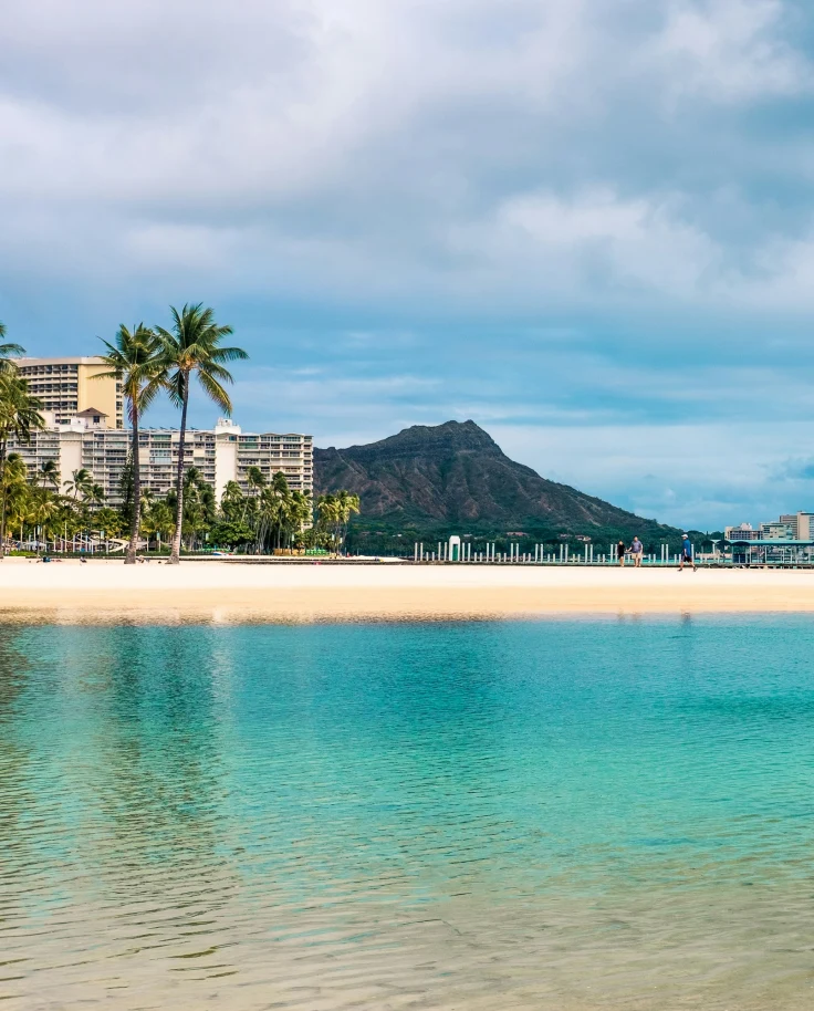 Beach view with a mountain in the distance during daytime