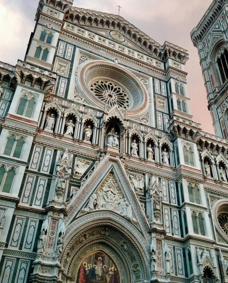 A low-angled view of a large, gothic-style cathedral during the daytime