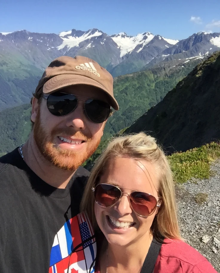 A couple with mountains at the back.