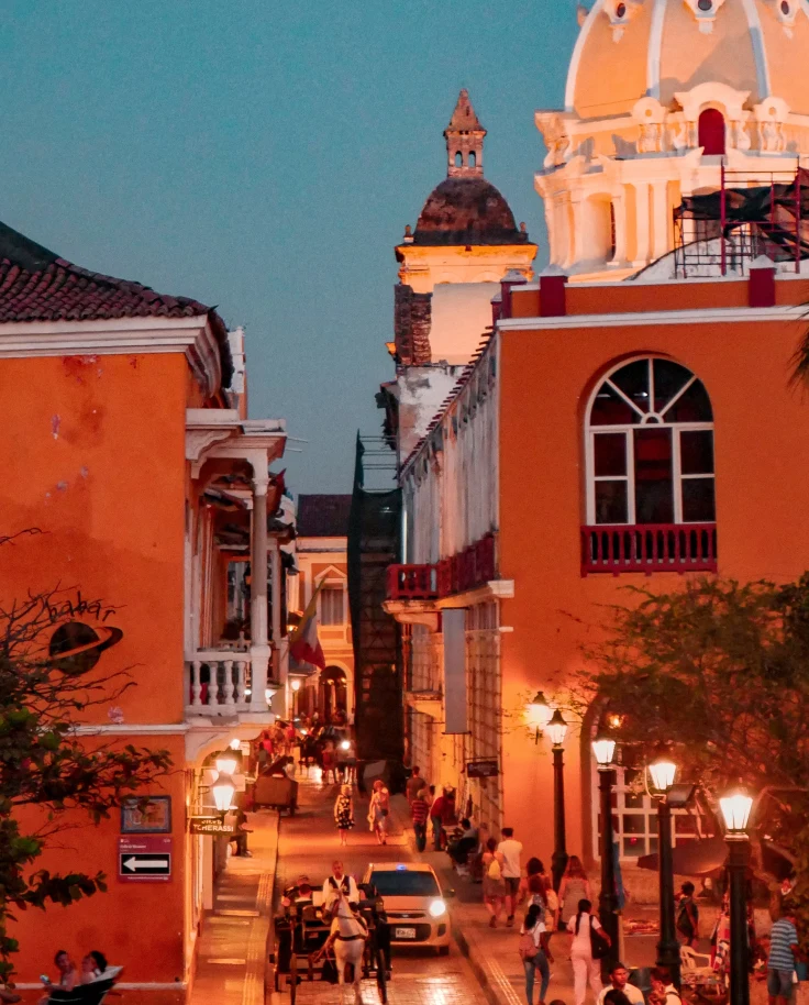 orange buildings next to street during nighttime