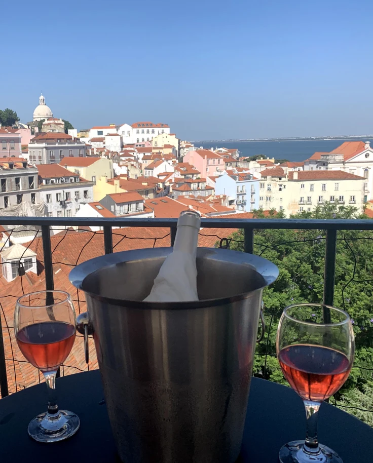 A nice glass of wine and the views of Lisbon in the distance.