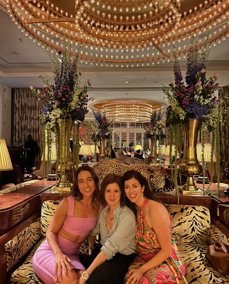 Three women posing on a couch in doors