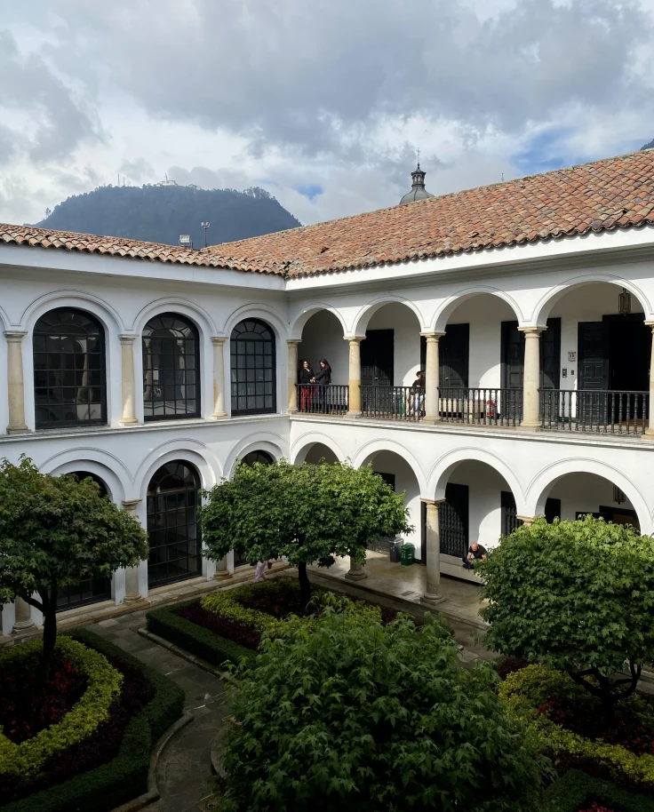 A white building with arched entryways during the daytime