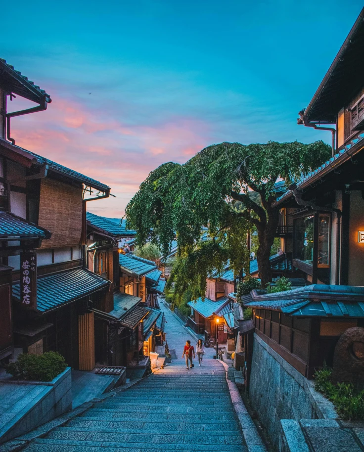 A picture of the brown wooden houses near green trees during daytime.