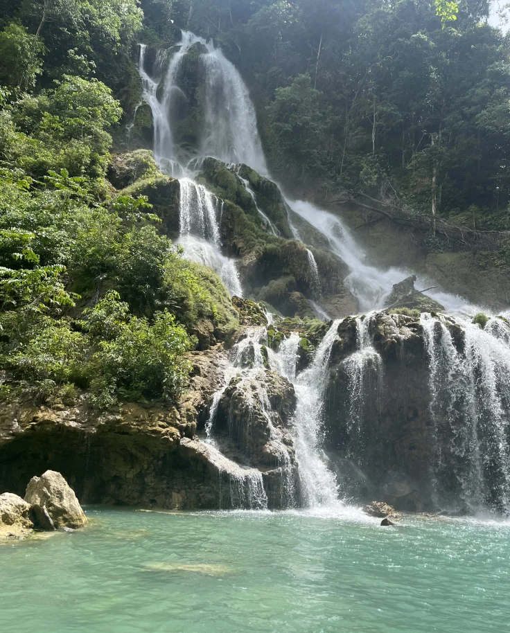 waterfall with large swimming hole during daytime