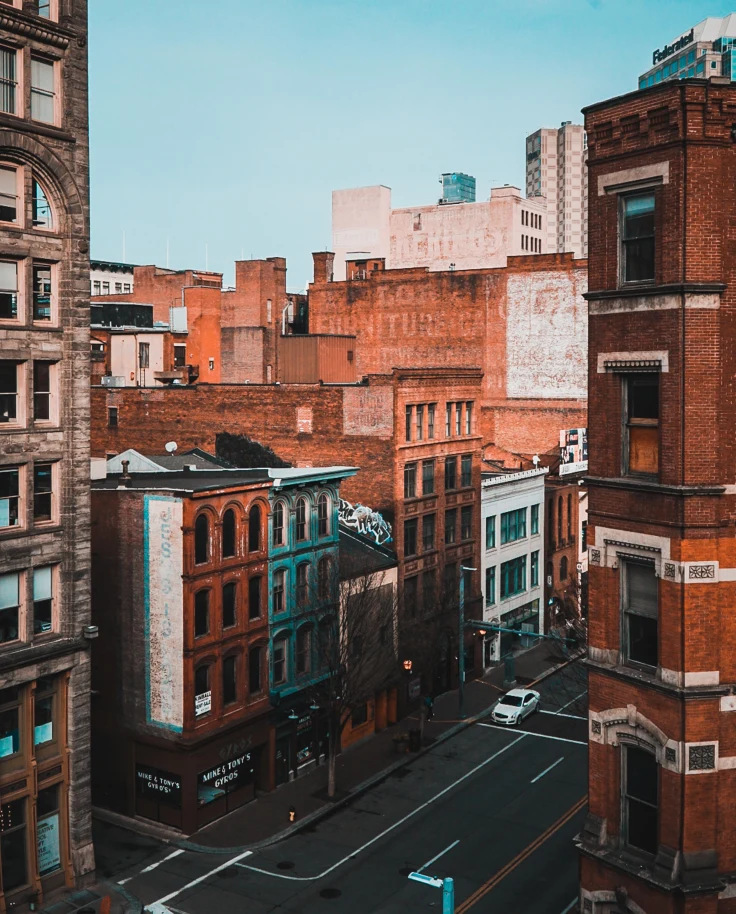 Orange and white buildings with the street and a blue sky