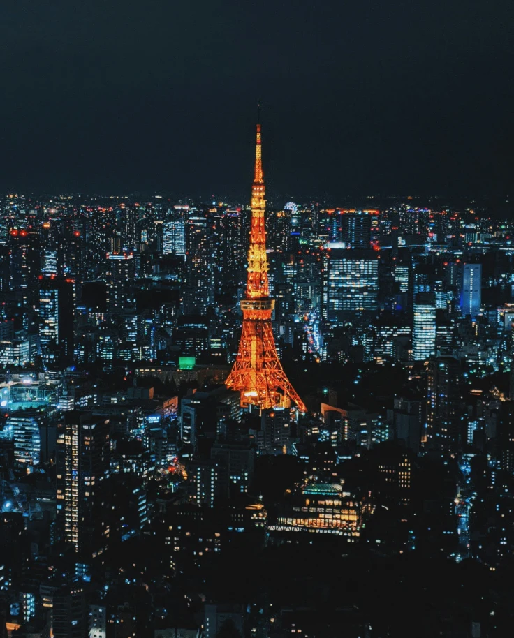 A lit-up skyline with Tokyo Tower in the center at nighttime.