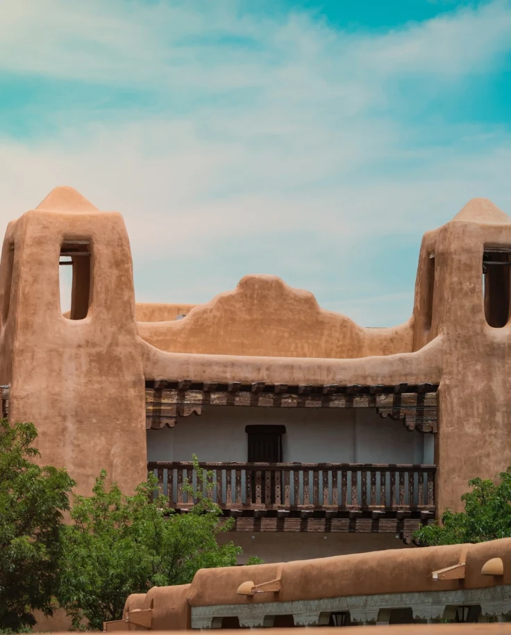 Southwestern adobe home set against a turquoise sky