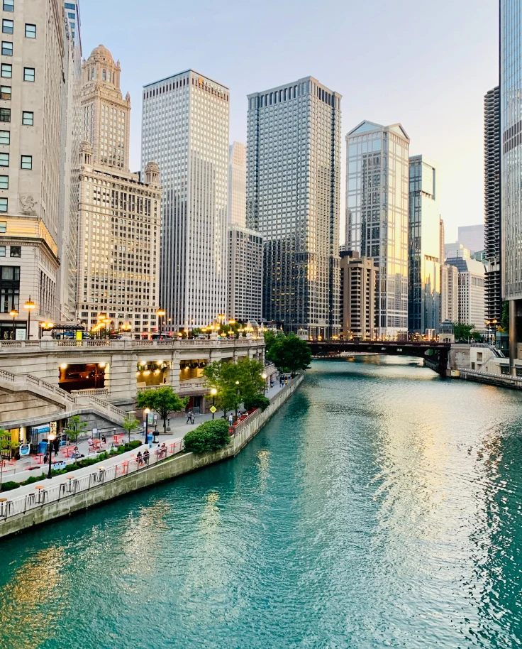 Body of water lined with tall buildings during daytime