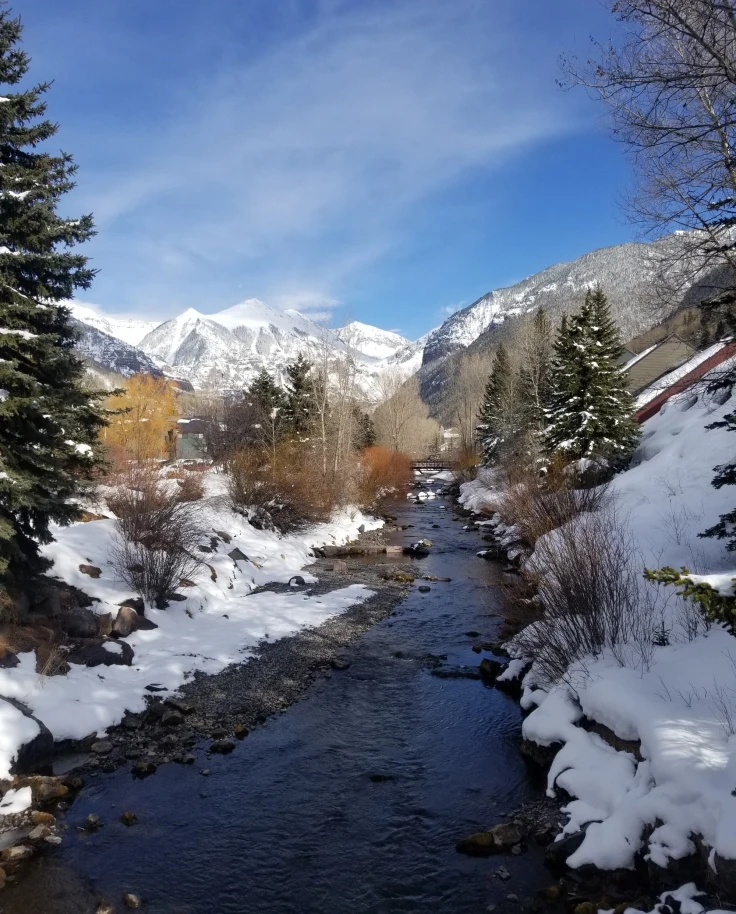 stream through snowy mountain range