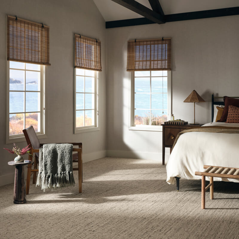 textured carpet in bedroom with shades on windows