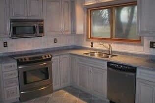 Kitchen countertop, flooring and backsplash remodeling work by Richwell Carpet & Cabinets in Fairfield, IA