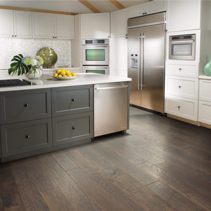 dark flooring in a kitchen with darker cabinets