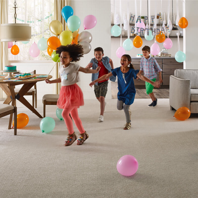 children playing on carpeted flooring in living room