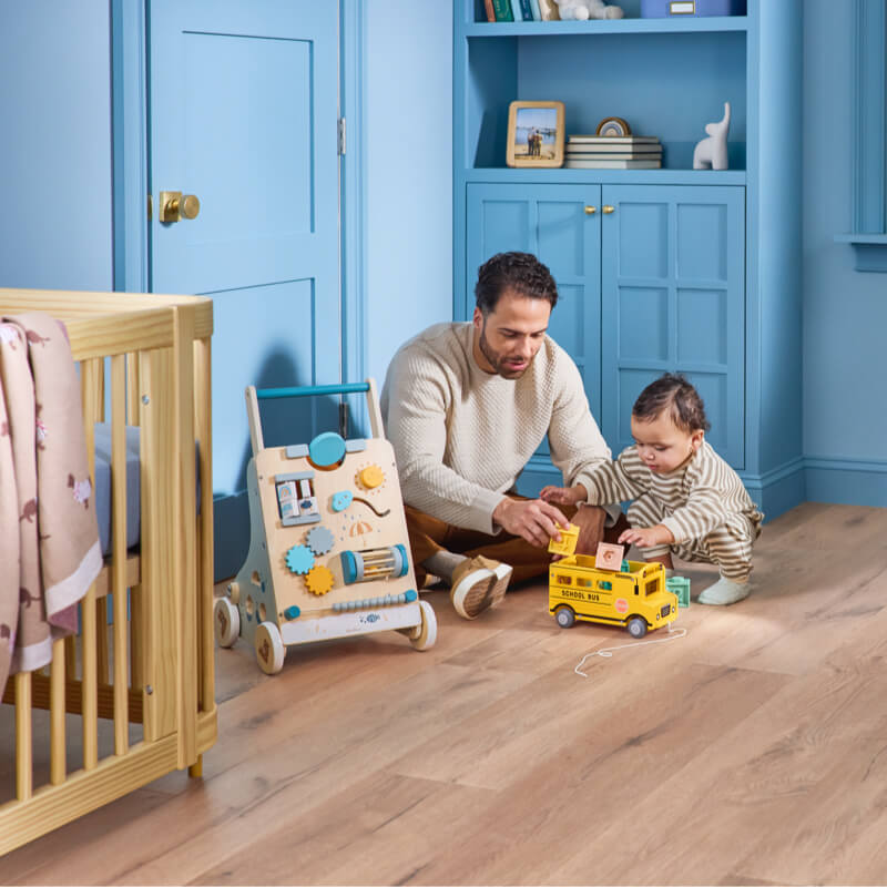father playing with baby on luxury vinyl flooring