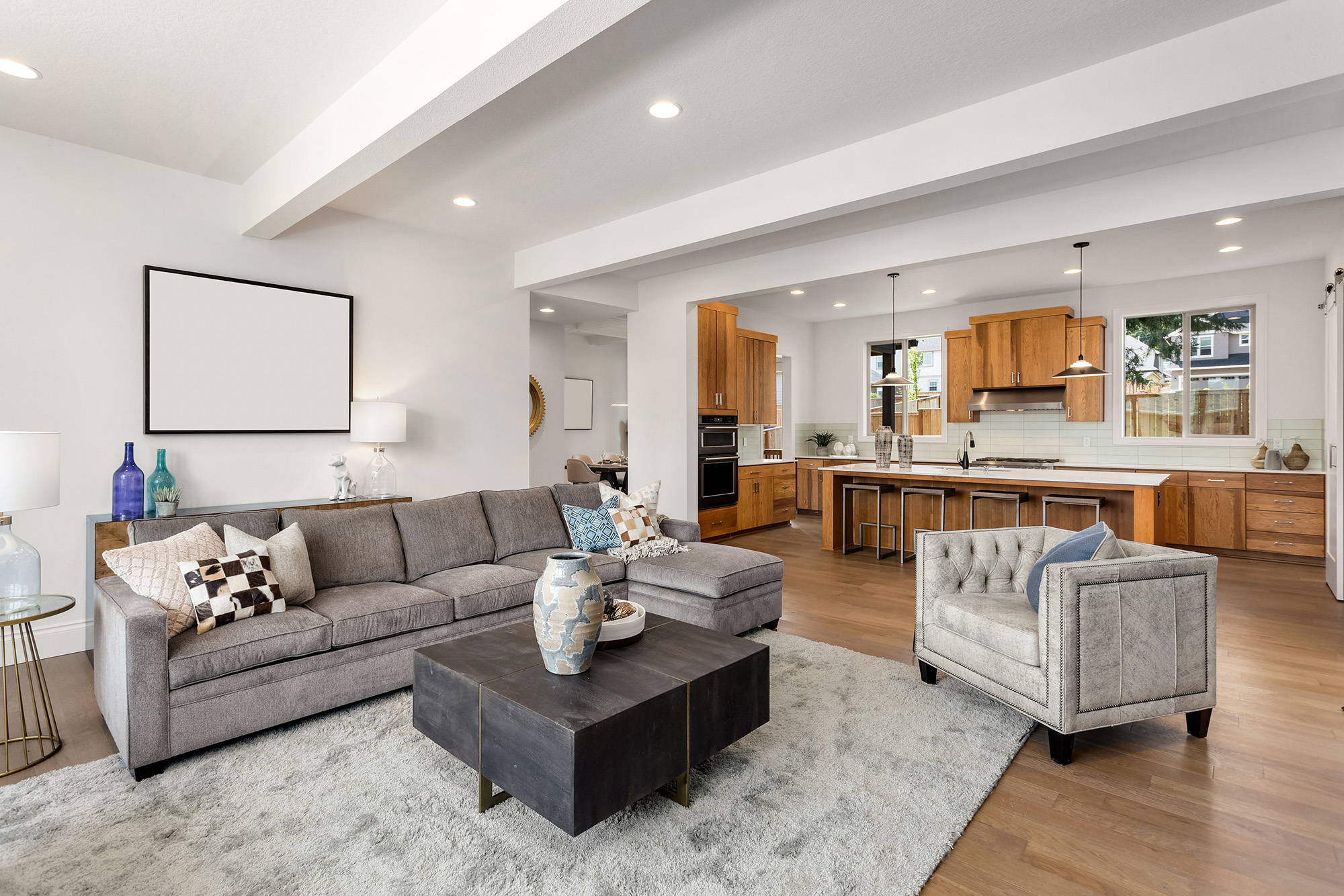Spacious open-concept living room and kitchen with beautiful hardwood flooring by Markville Flooring in Toronto and Markham Ontario. 