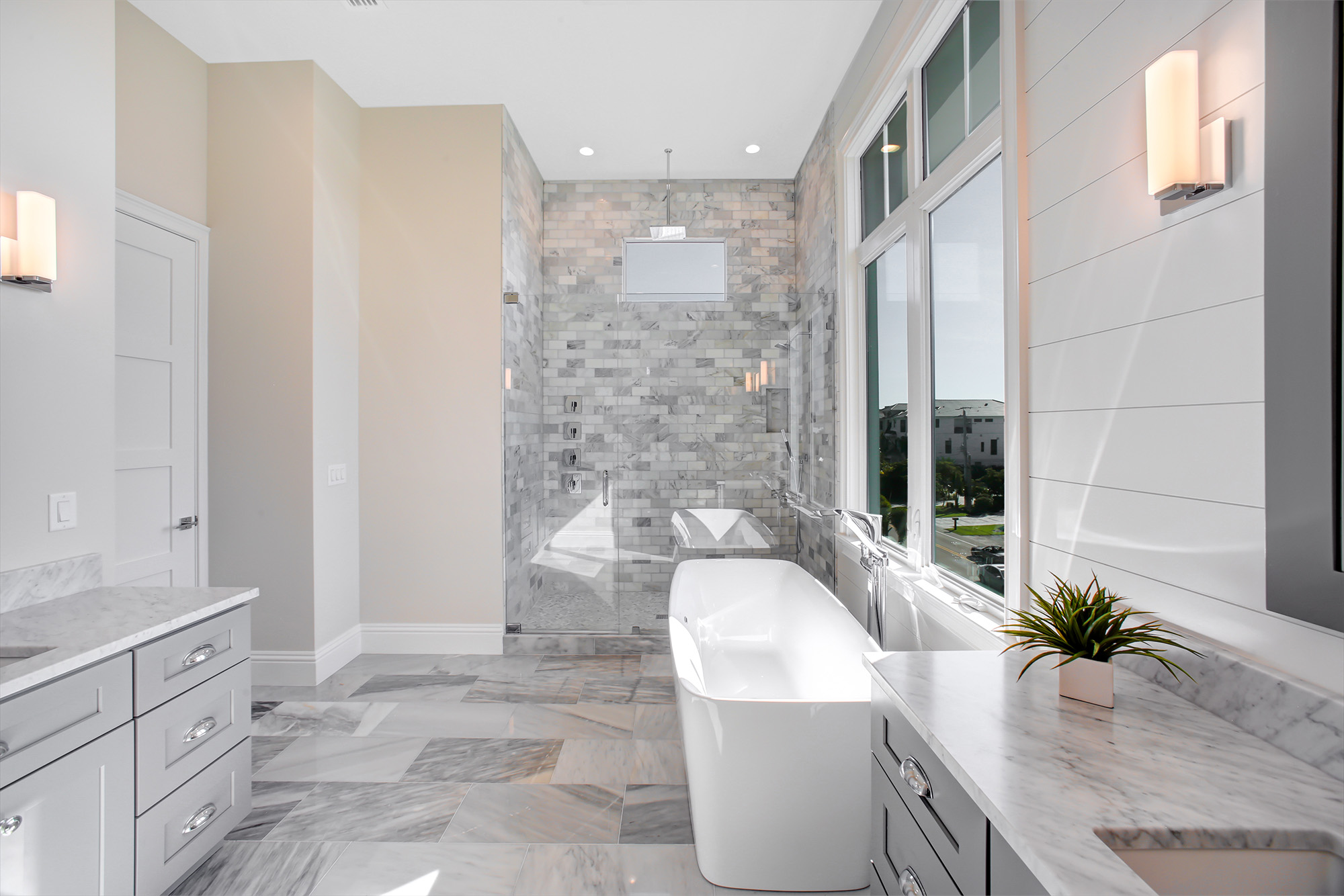A Fresh Look for Your Bathroom tiles, gray style and single tub by Hadingers in Fort Myers Florida.
