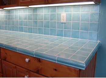 A kitchen counter top with blue tiles