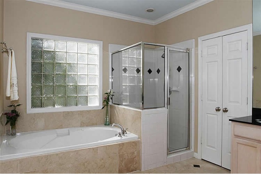 A bathroom with a bathtub and shower