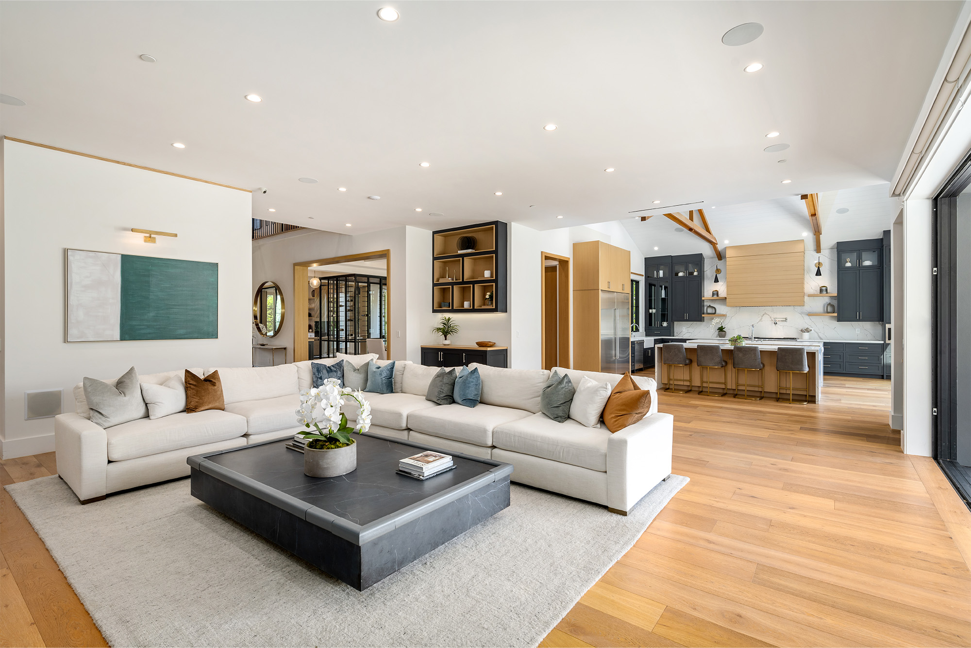Spacious open-concept living room and kitchen with beautiful hardwood flooring by Markville Flooring in Toronto and Markham Ontario. 