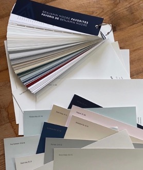 A fan of paint samples on a tableDescription automatically generated
