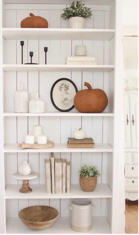 A white shelf with objects on itDescription automatically generated