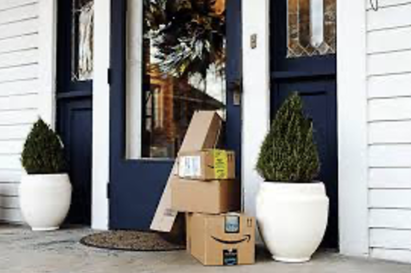 A stack of boxes outside a doorDescription automatically generated
