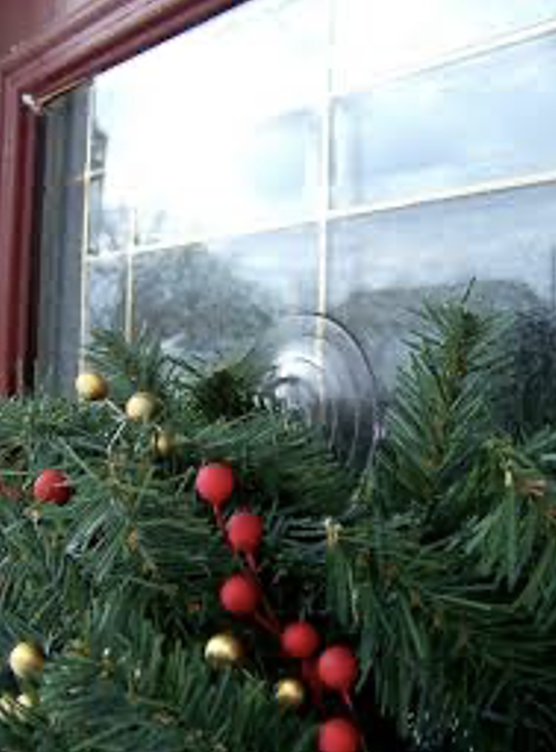 A close-up of a window with a wreathDescription automatically generated
