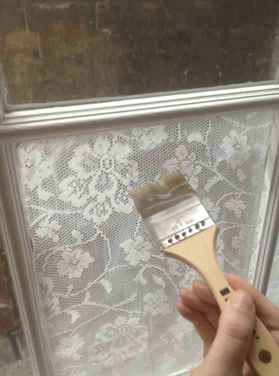 A person painting a windowDescription automatically generated