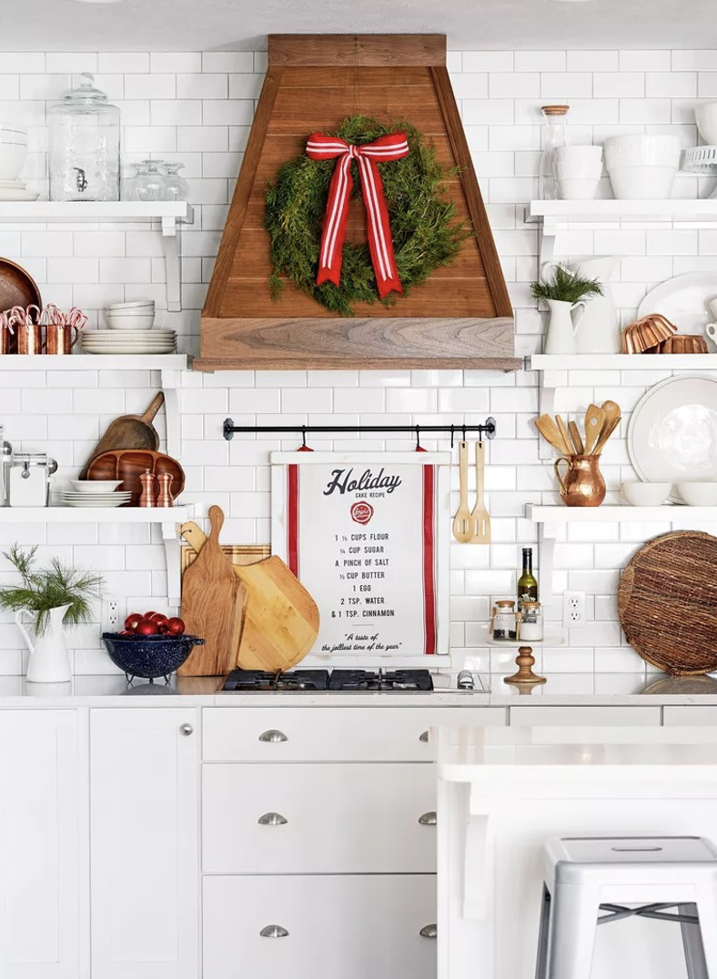 A kitchen with a wreath and a sign above itDescription automatically generated