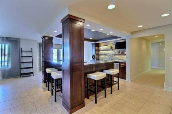 dark beams and contrasting porcelain tile dress up this kitchen and great room remodel and look at that backsplash