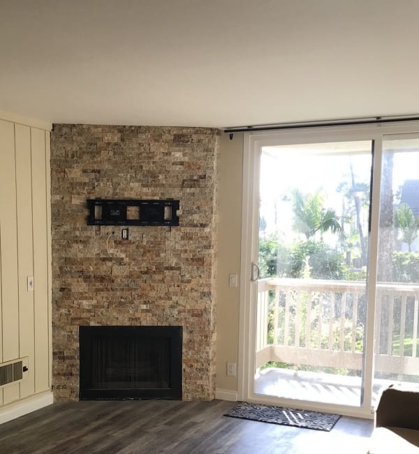 Stone fireplace and wood flooring in North County, CA from SavOn Flooring