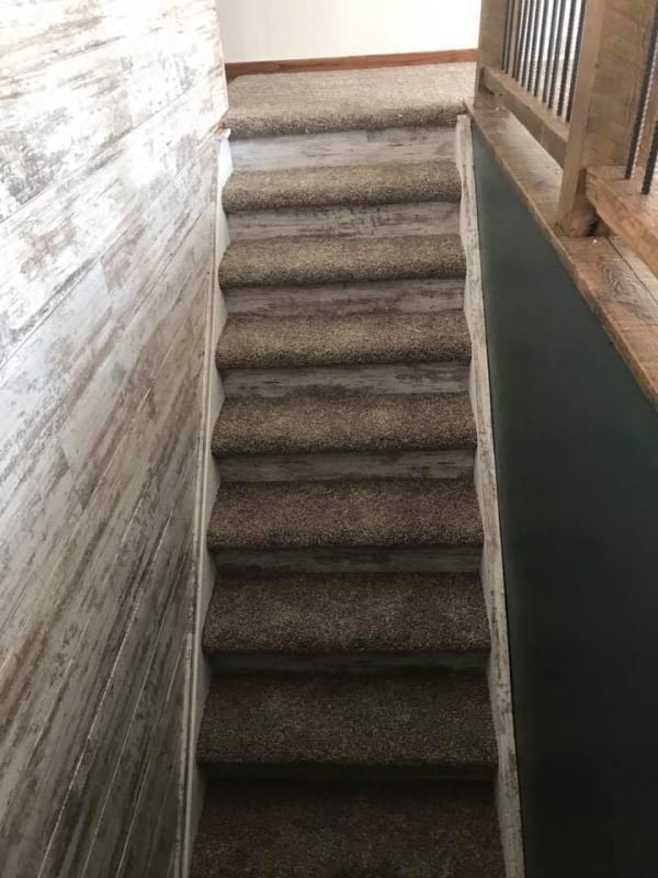 woodlook tile on the walls and carpet on the stairs 