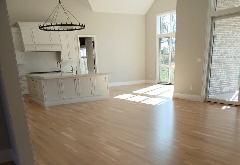 Bright white kitchen with hardwood floors in a Ladue home renovation.