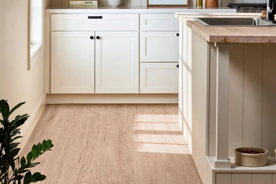 light, neutral laminate flooring in kitchen with white elemeents