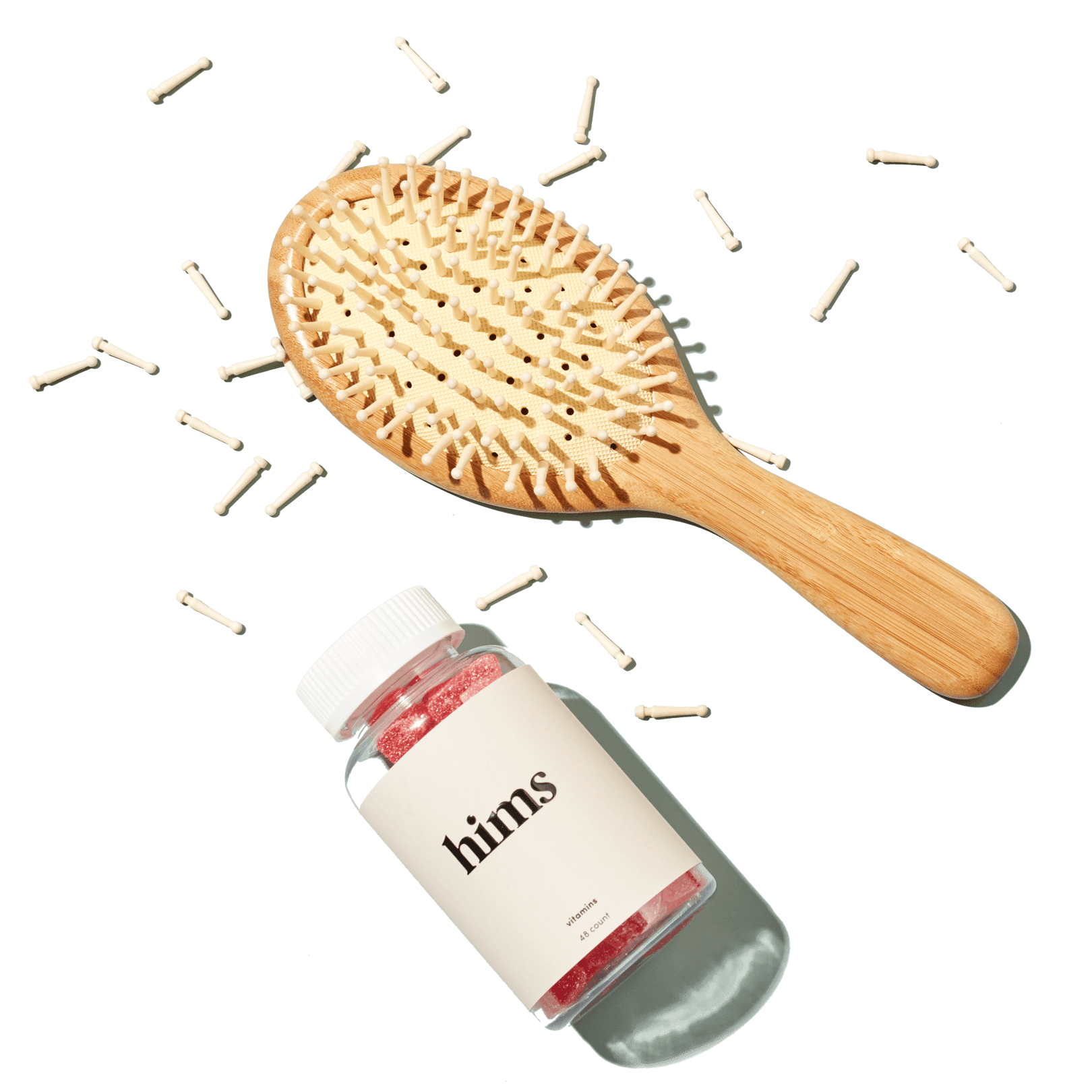 a hair brush with bristles falling out and a bottle of gummies