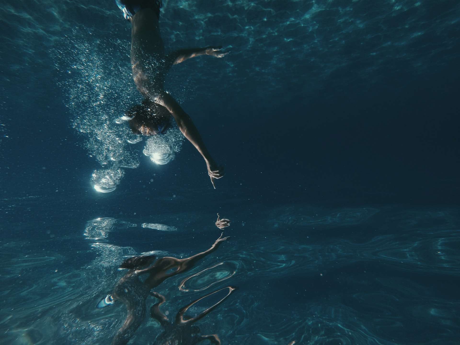 Photo by Marin Sattler on Unsplash of someone underwater