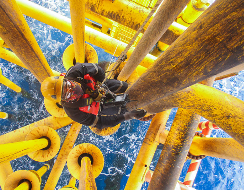 Man climbing with safety rope over water Man climbing with safety rope over water