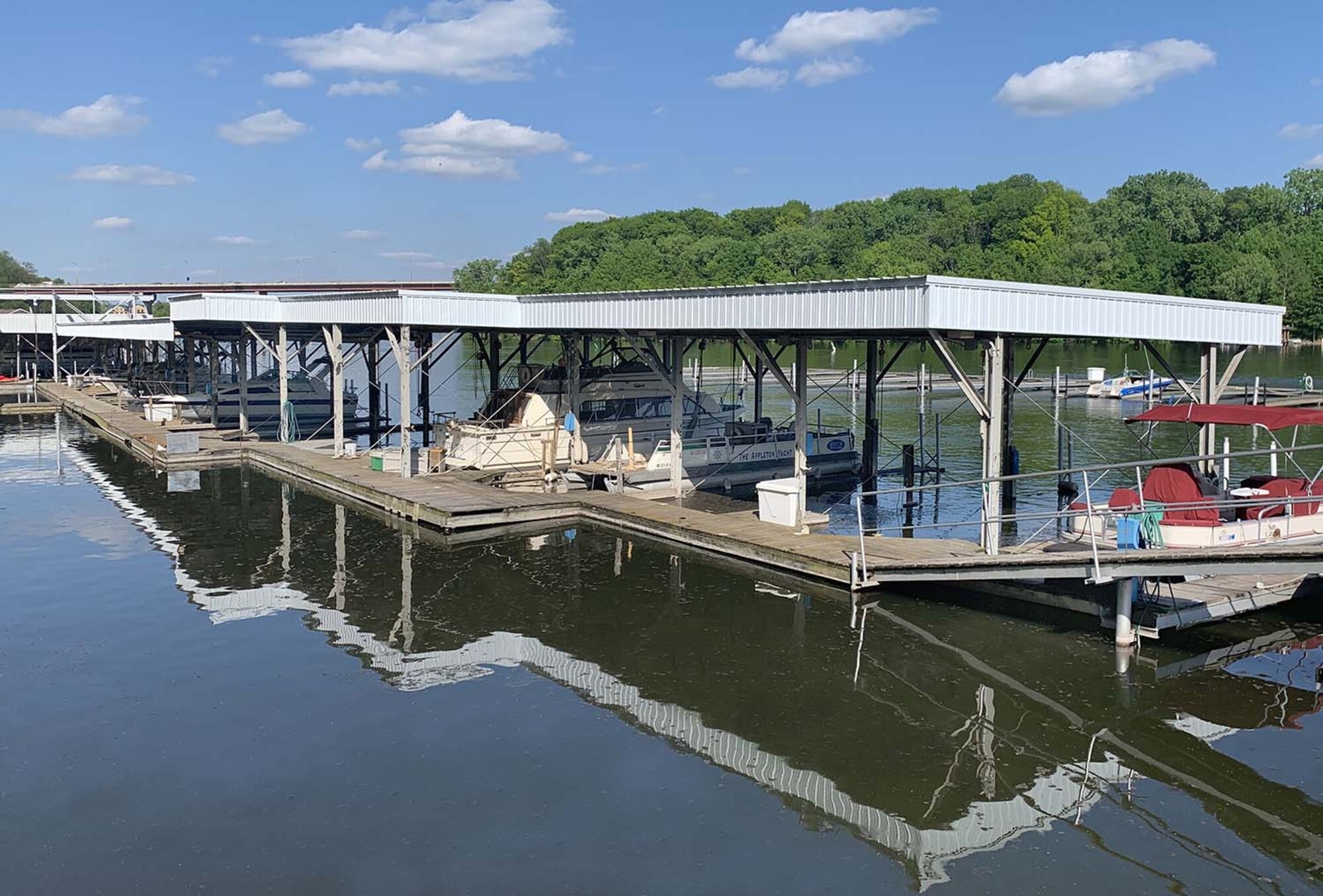 Covered boat docks with new roofing at the Appleton Yacht Club