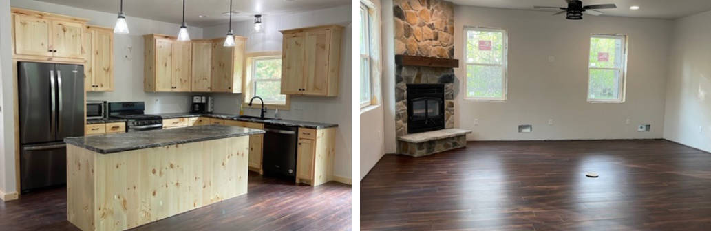 Kitchen with large island and living room with large rock corner fire place