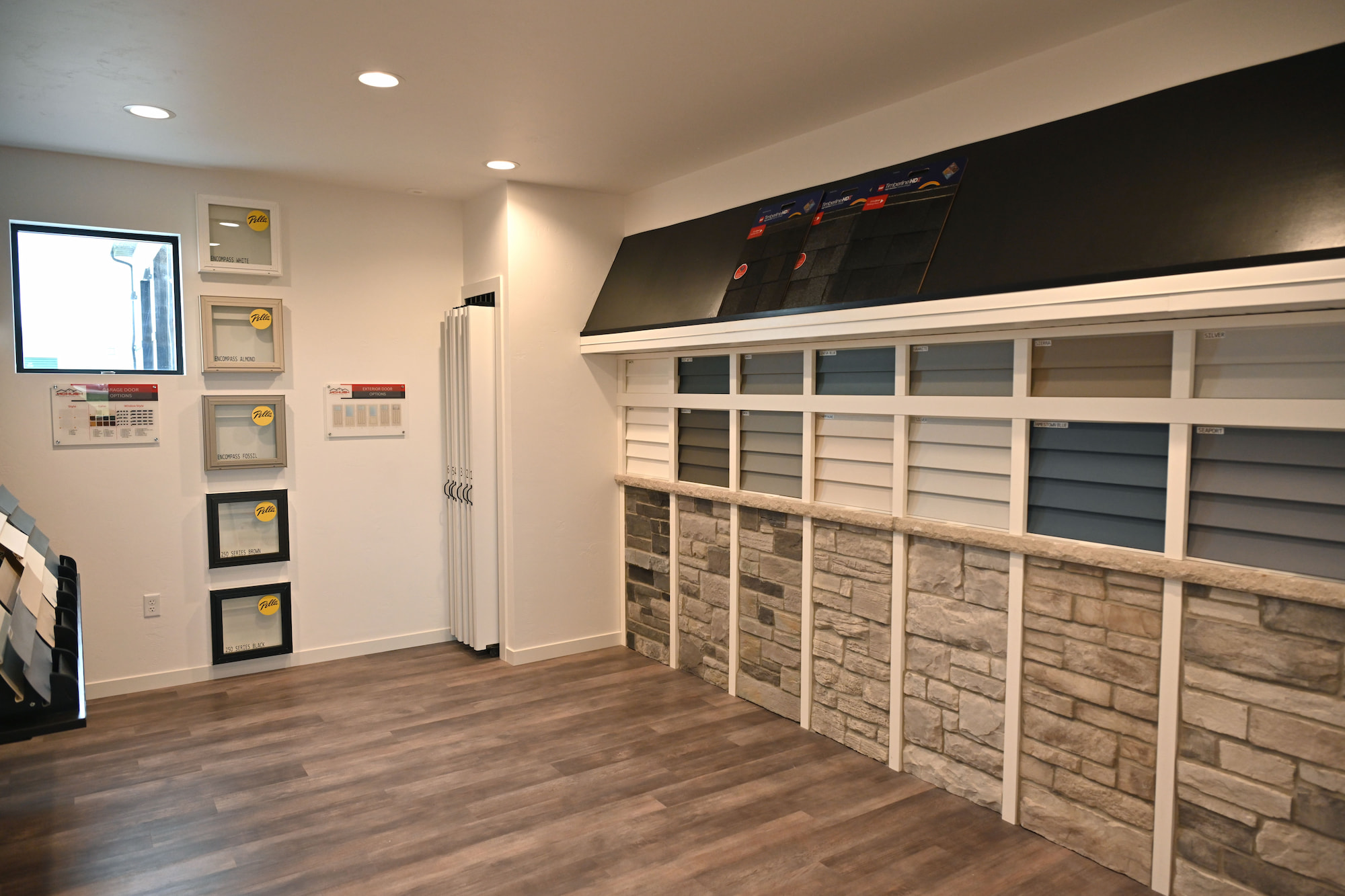 Interior showroom featuring siding, windows and brick samples