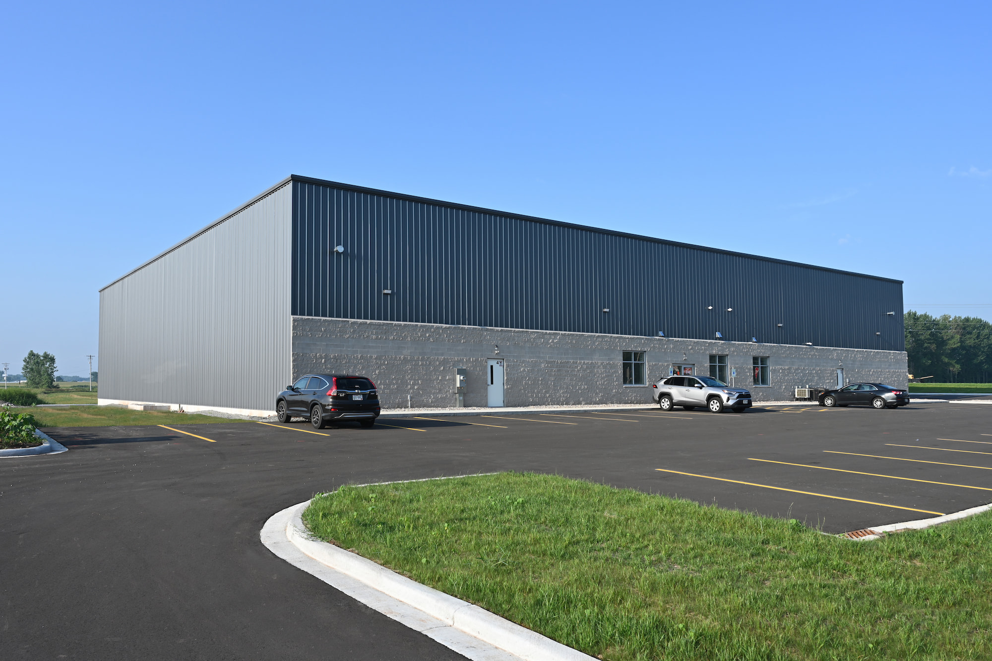 Newly constructed commercial warehouse with paved parking lot in Kaukauna, Wisconsin.