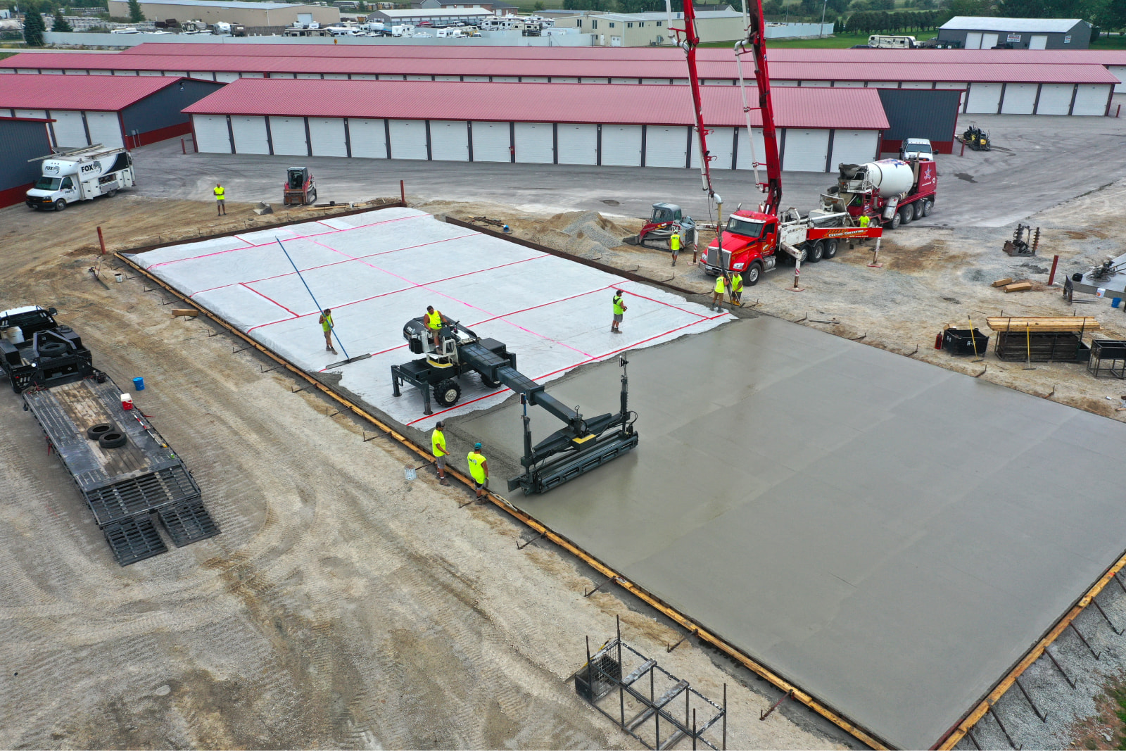 Large concrete slab being poured at storage facility