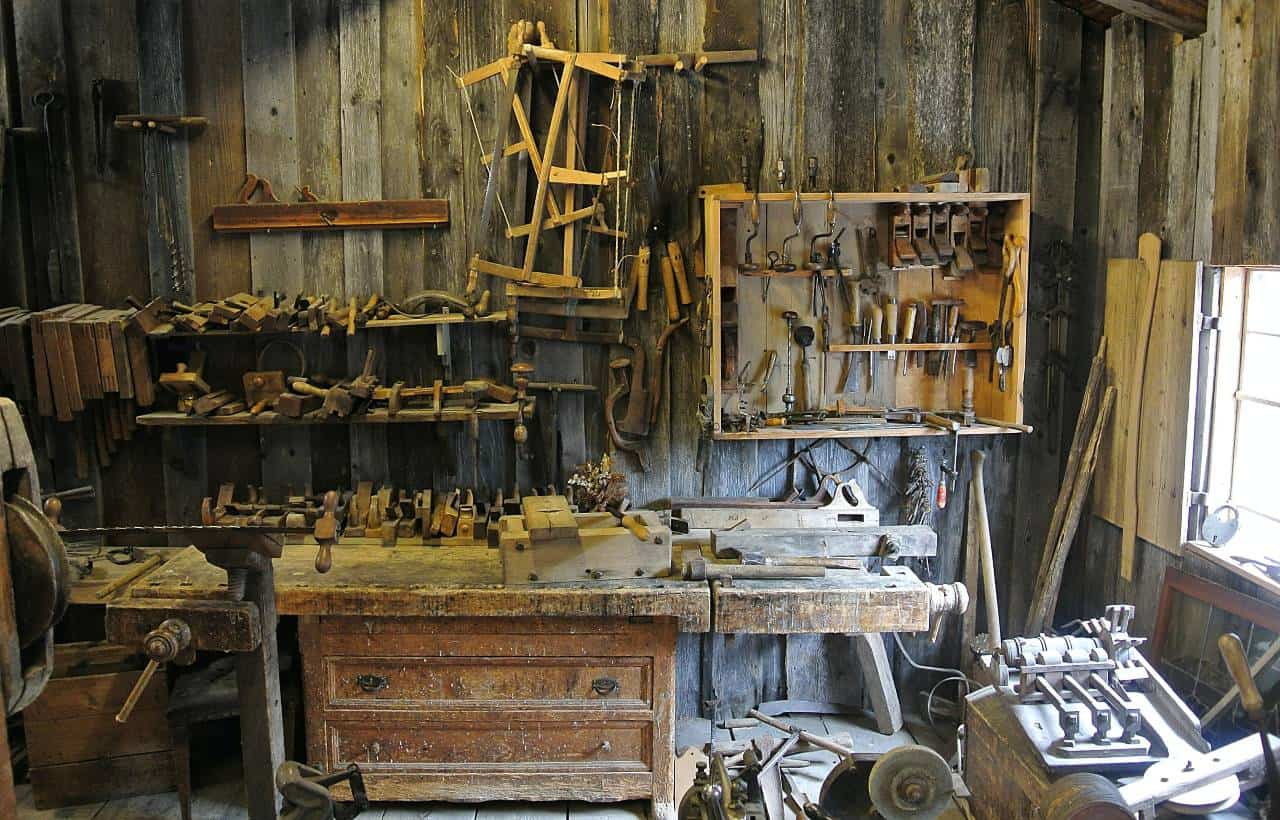 A cluttered wood working shop in a barn